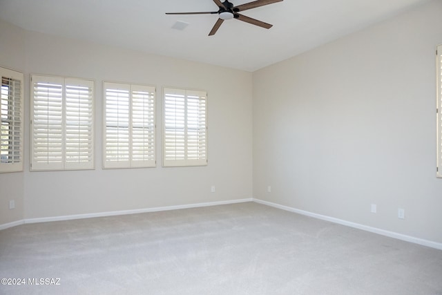 carpeted spare room with ceiling fan