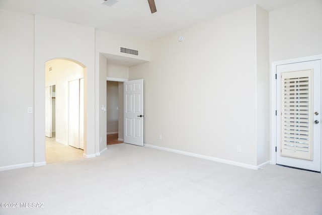 unfurnished room with ceiling fan and light colored carpet