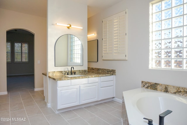 bathroom featuring tile patterned floors, vanity, and a wealth of natural light