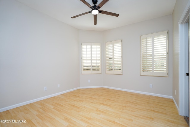 spare room with light wood-style flooring, baseboards, and ceiling fan