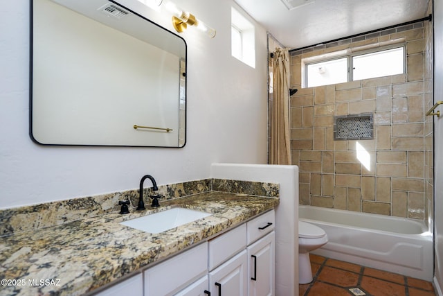 full bathroom featuring toilet, tile patterned floors, vanity, visible vents, and shower / tub combo with curtain