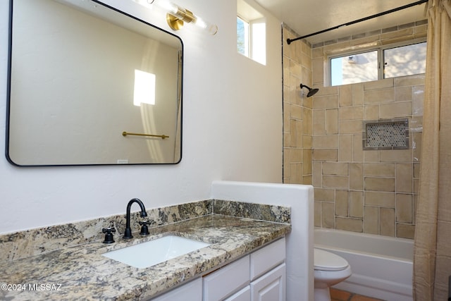 full bathroom with tiled shower / bath combo, toilet, and vanity