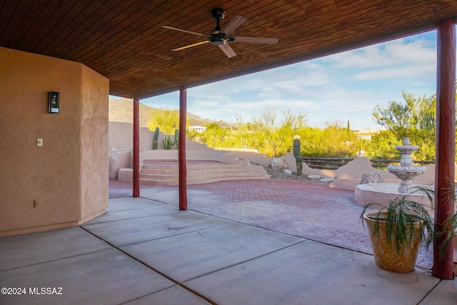 view of patio / terrace featuring ceiling fan and a mountain view