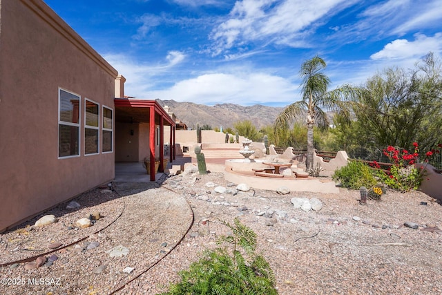 view of yard featuring a patio area, fence, and a mountain view