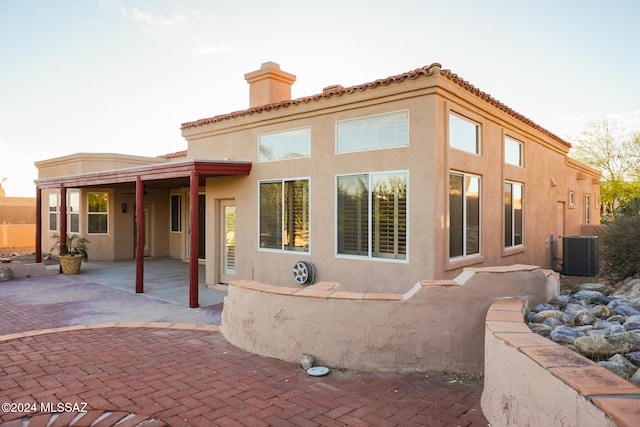 back of house featuring cooling unit and a patio