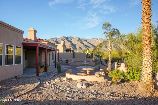 view of yard featuring a mountain view and a patio