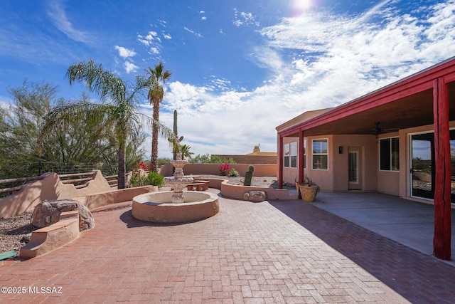 view of patio / terrace with fence and a ceiling fan