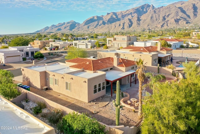 drone / aerial view featuring a residential view and a mountain view