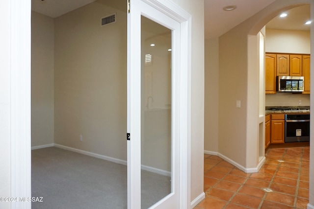 corridor with light tile patterned flooring