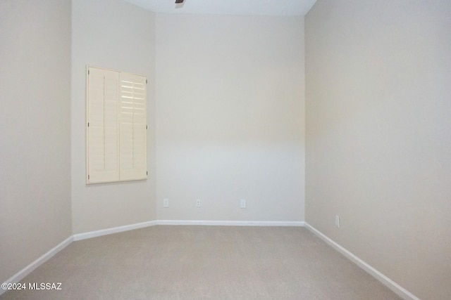 spare room featuring ceiling fan and carpet