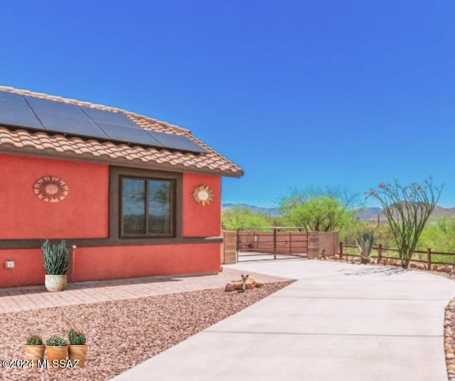 view of side of property with solar panels