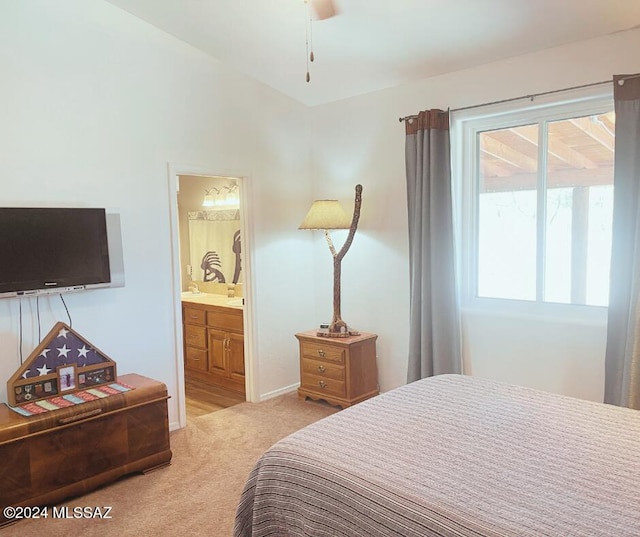 bedroom featuring ensuite bath, ceiling fan, and light colored carpet