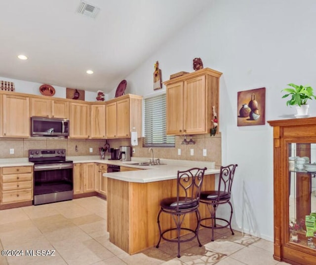 kitchen with light brown cabinets, sink, appliances with stainless steel finishes, tasteful backsplash, and kitchen peninsula