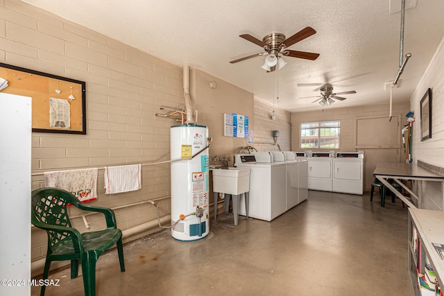 interior space with sink, ceiling fan, a textured ceiling, washing machine and clothes dryer, and water heater