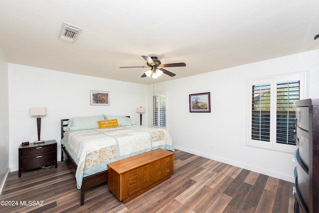 bedroom featuring a textured ceiling, ceiling fan, and dark hardwood / wood-style floors