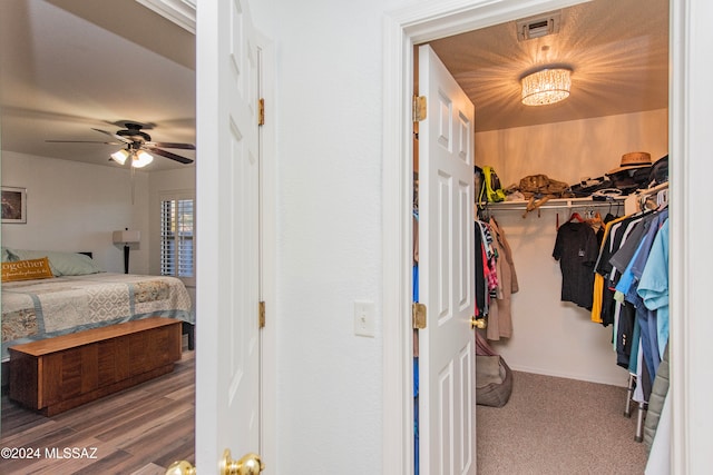 walk in closet featuring ceiling fan and hardwood / wood-style floors