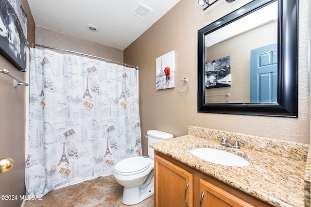 bathroom featuring tile patterned floors, vanity, and toilet