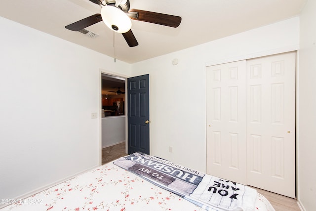 unfurnished bedroom with ceiling fan, light wood-type flooring, and a closet