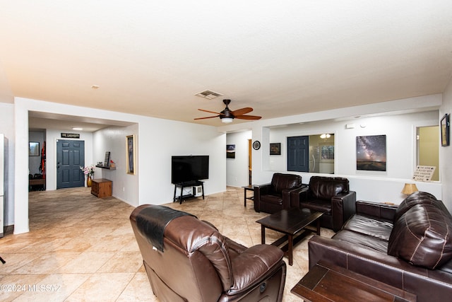 tiled living room with ceiling fan