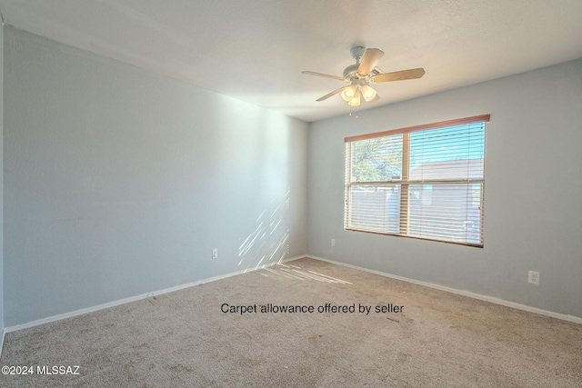 spare room featuring carpet and ceiling fan