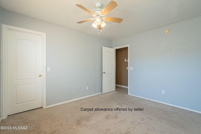 empty room with light colored carpet and ceiling fan