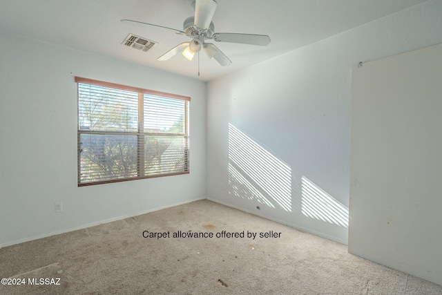 carpeted empty room featuring ceiling fan