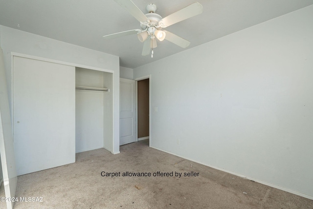 unfurnished bedroom featuring light carpet, a closet, and ceiling fan