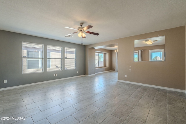 spare room with ceiling fan and a textured ceiling