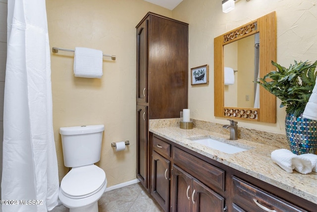 bathroom featuring tile patterned flooring, vanity, and toilet