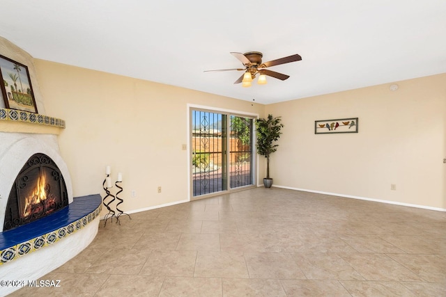 unfurnished living room featuring ceiling fan and light tile patterned floors