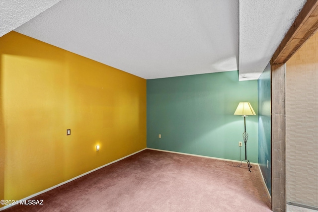 bonus room featuring carpet flooring and a textured ceiling