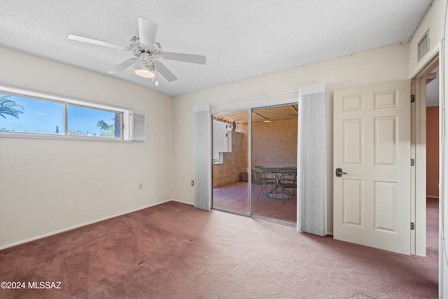 unfurnished bedroom featuring a closet, carpet, a textured ceiling, and ceiling fan