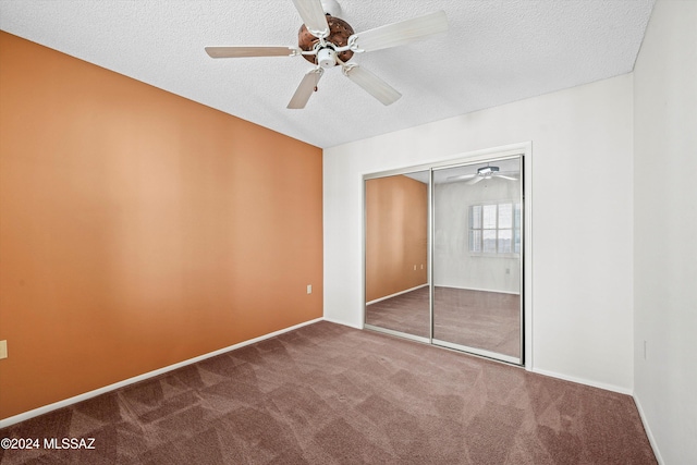 unfurnished bedroom featuring a closet, carpet, a textured ceiling, and ceiling fan