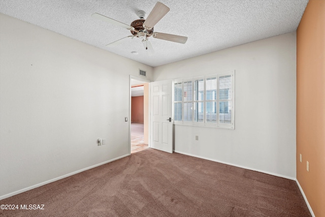 carpeted empty room with a textured ceiling and ceiling fan