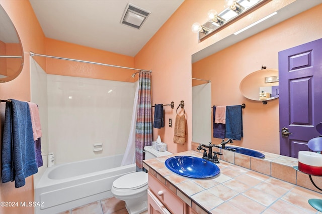 full bathroom featuring tile patterned flooring, vanity, toilet, and shower / tub combo with curtain