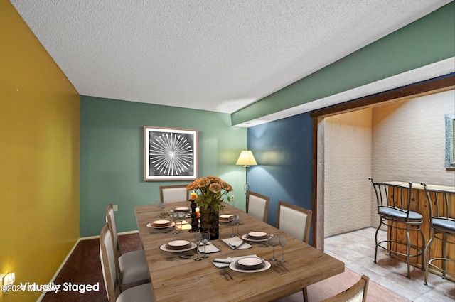 dining space featuring a textured ceiling