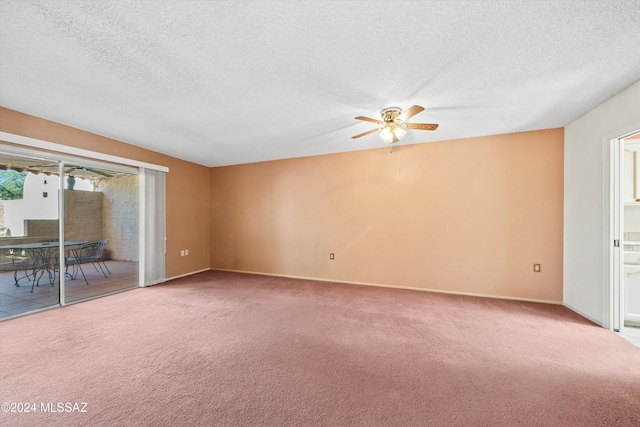 carpeted spare room with ceiling fan and a textured ceiling