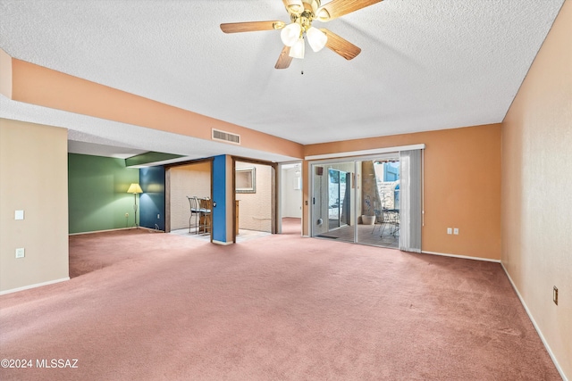 spare room featuring ceiling fan, a textured ceiling, and carpet flooring