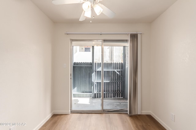 spare room featuring light hardwood / wood-style floors and ceiling fan