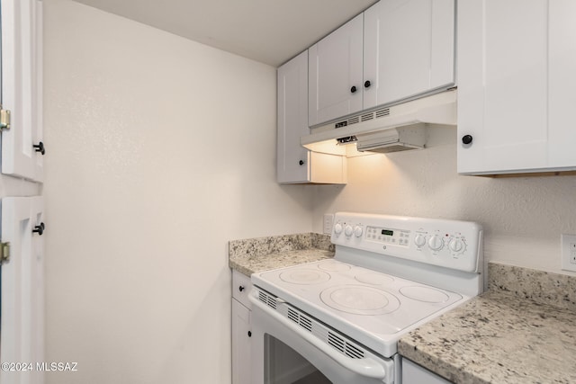 kitchen featuring white range with electric stovetop, white cabinetry, and light stone countertops