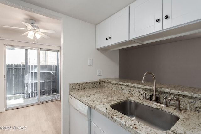 kitchen featuring light hardwood / wood-style floors, sink, light stone counters, white cabinets, and dishwasher