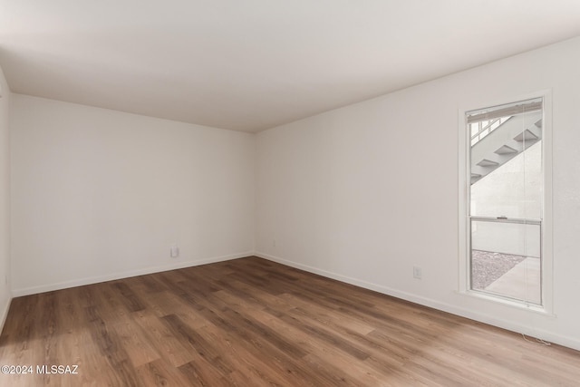 spare room with hardwood / wood-style floors