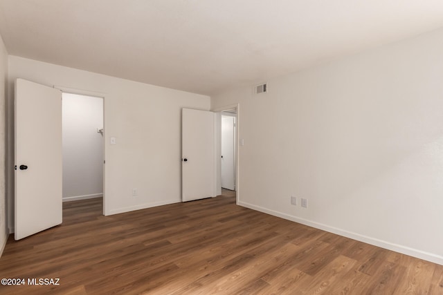 unfurnished room featuring dark wood-type flooring