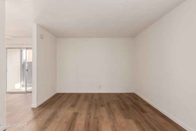 unfurnished room featuring dark hardwood / wood-style flooring