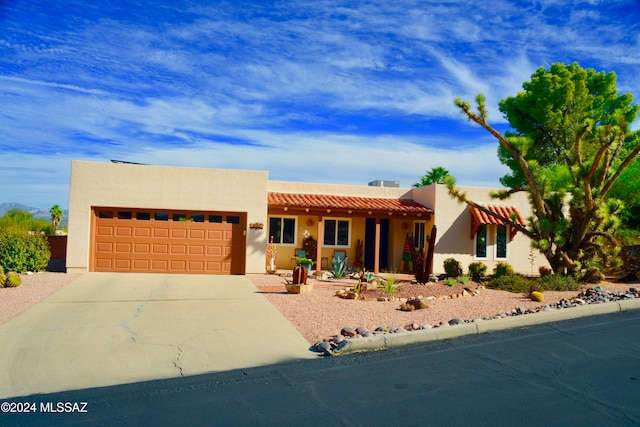 pueblo-style home with a garage