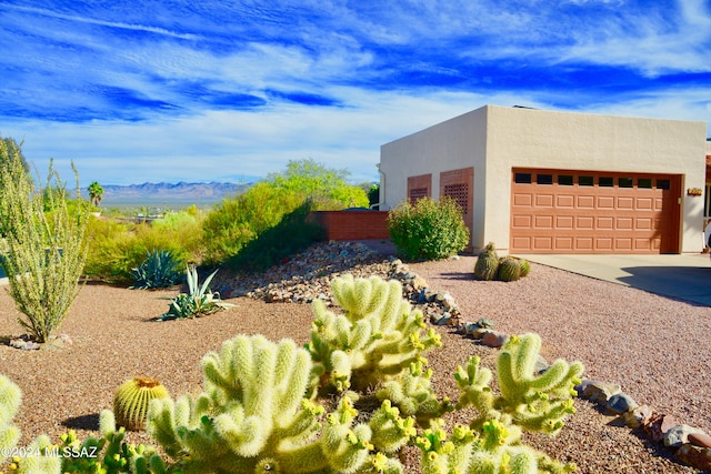 view of home's exterior with a mountain view and a garage