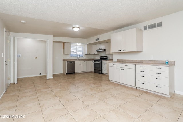 kitchen featuring stainless steel dishwasher, a textured ceiling, sink, white cabinets, and black gas range