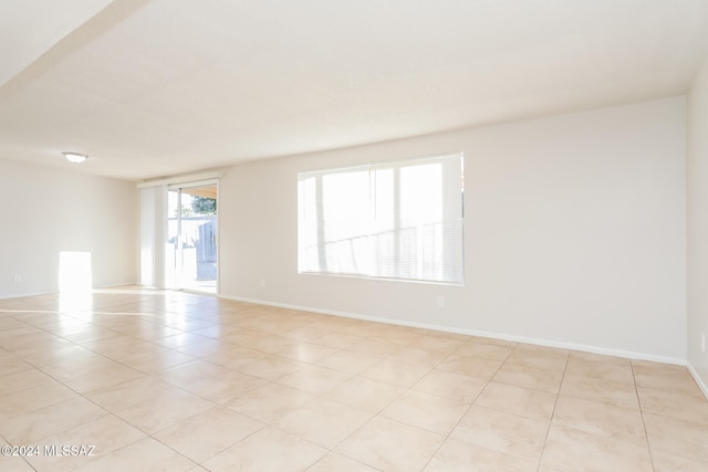 unfurnished room featuring light tile patterned floors