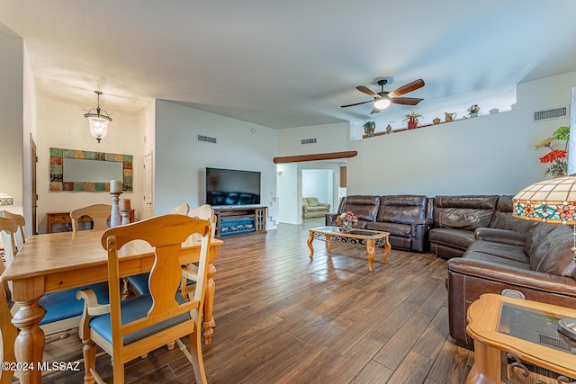 living room with ceiling fan and dark hardwood / wood-style flooring