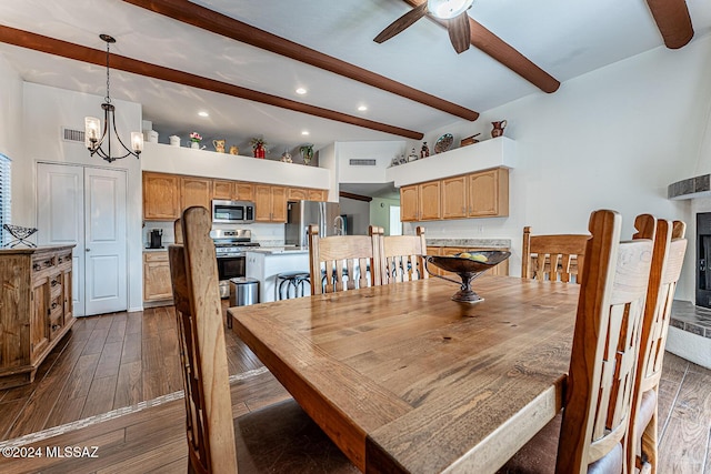 dining space with vaulted ceiling with beams, ceiling fan with notable chandelier, and dark hardwood / wood-style floors